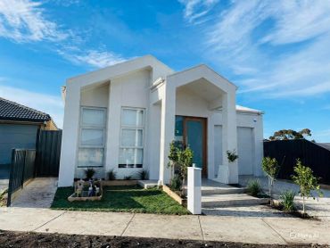 Modern white house with a blue sky.