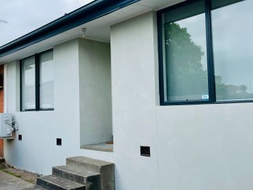 Modern house entrance with concrete steps.
