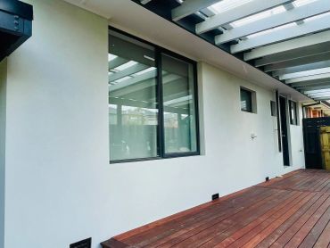 Modern patio with wooden deck and glass roof
