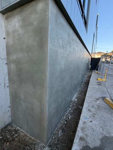 Freshly plastered building corner with clear sky.