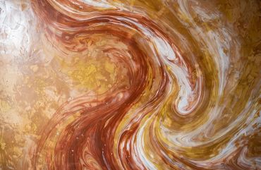 Abstract swirling pattern in brown, yellow, and white.