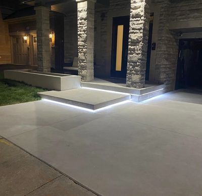 Modern porch steps with elegant LED strip lighting at night.