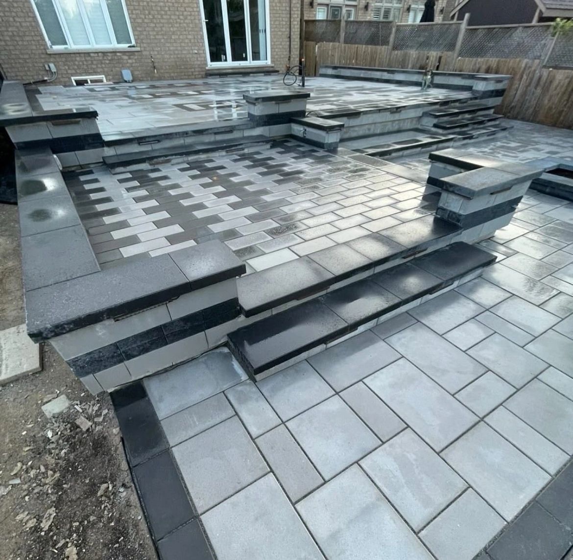 This custom interlocking patio and tiered stone steps project showcases a modern outdoor living space designed for durability, functionality, and visual appeal. Professionally installed by trusted concrete experts near me, this multi-level interlock layout features high-quality gray pavers, precise stone edging, and clean step transitions that enhance both safety and style. Serving homeowners across Toronto, Vaughan, and the Durham Region, this interlocking patio is built to withstand heavy use and changing weather while adding long-term value and curb appeal to the property.

SEO Keywords: concrete experts near me, interlocking patio installation, interlocking stone steps, backyard interlocking patio, residential interlocking contractors, interlocking patio Toronto, interlocking patio Vaughan, interlocking patio Durham Region, modern interlock design, custom interlocking patio, professional concrete and interlocking contractors