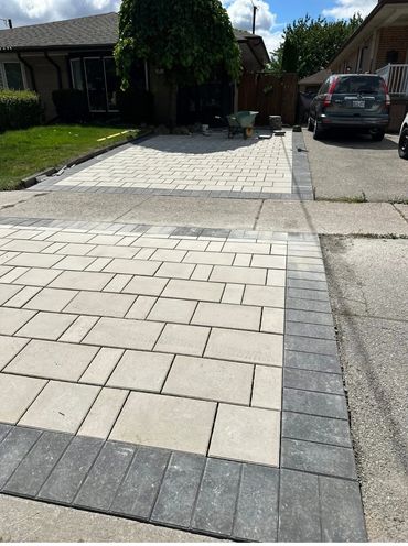 Newly paved driveway with light and dark rectangular stones.