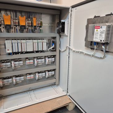 Open electrical control panel with wiring and components.