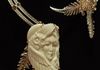 A bone cabochon of an owl surrounding a lady’s face for an asymmetrical collar  with two bands of sterling and gold filled wire separated by wraps