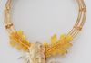 An Indonesian hand carved wooly mammoth tusk cabochon from Alaska The framework is two bands of sterling silver and gold filled wires with oak leaves.