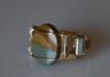 A Cripple Creek Jasper cabochon set in gold fill wire with sterling silver wraps on each side.  Size 13