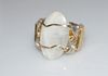 An oval rainbow moonstone cabochon set in sterling silver wire with gold-filled wraps and gold filled center wire