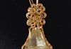 A vintage foil backed crystal is wrapped in gold filled wire highlighting the foil color and shaped to match the bell. 