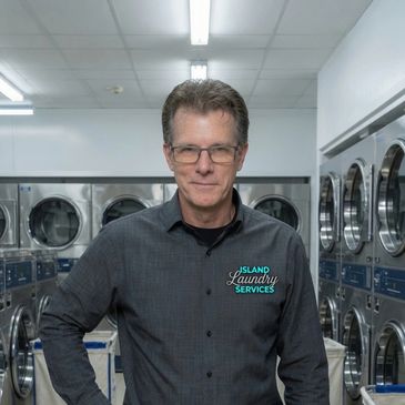Man standing in a laundromat.