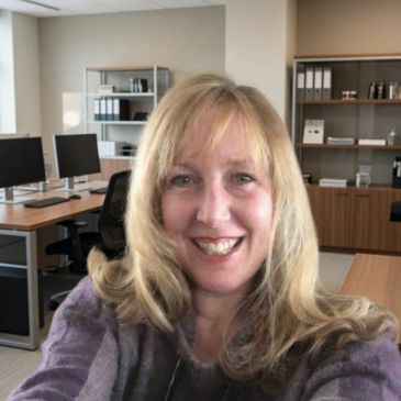 Woman smiling in an office.