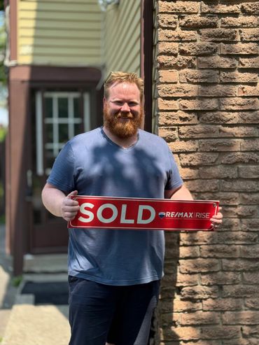 a person holding something in front of their house