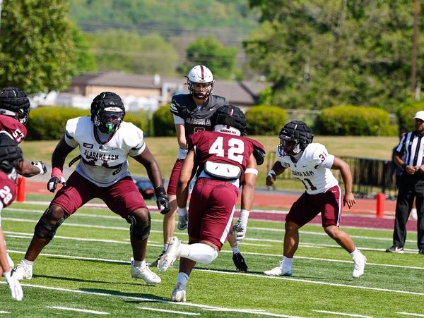 Players engaged in an intense football play on the field.