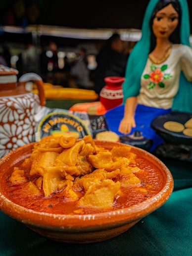 Traditional Mexican dish served in a rustic clay bowl with vibrant colors.