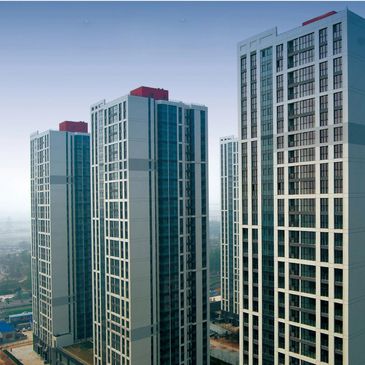 Modern high-rise residential buildings under clear blue sky.