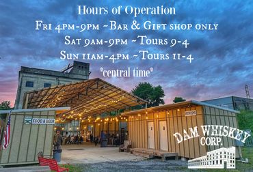 Dam Whiskey Corp. building with hours of operation sign and evening sky.