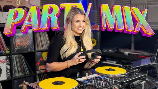 Female DJ mixing music with colorful turntables under vibrant 'PARTY MIX' text.