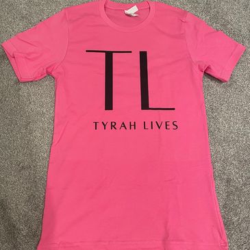 Pink T-shirt with 'TL Tyrah Lives' printed.