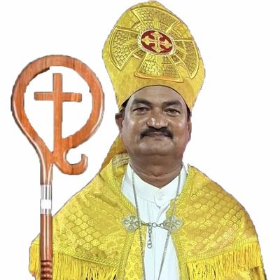 A bishop in golden ceremonial robes holding a wooden crozier with a cross.