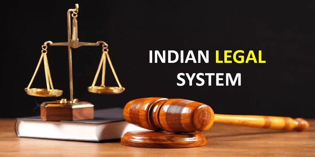 Wooden gavel and scales of justice with Indian Legal System text.