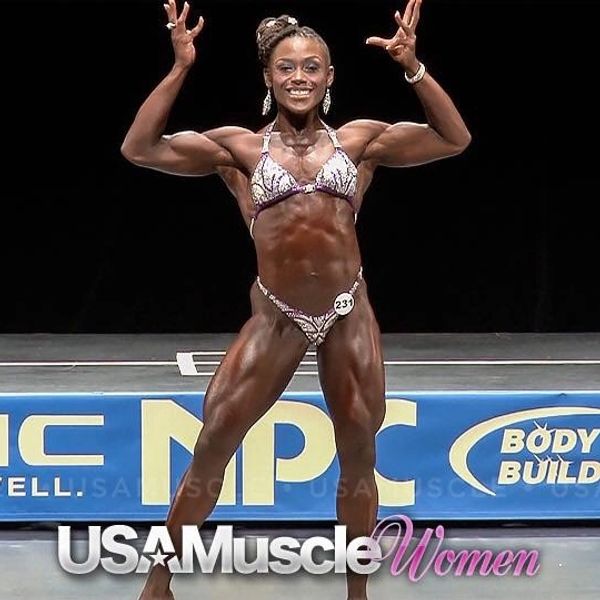 Female bodybuilder posing confidently on stage at a competition.