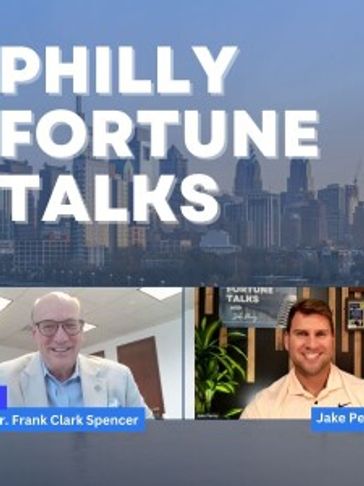 Two men discuss on Philly Fortune Talks with city skyline background.