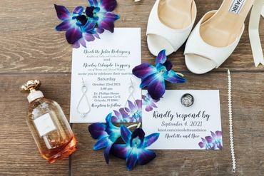 blue galaxy orchids with perfume bottle, wedding invitation and bride's shoes