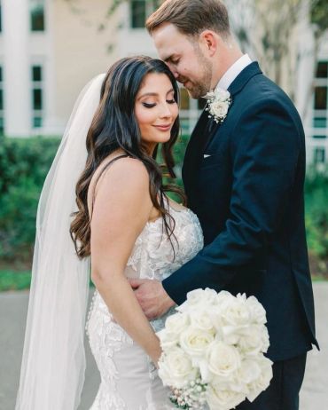 Bride and groom in a tender wedding moment.