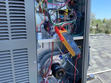 Performing maintenance inspection on package unit.