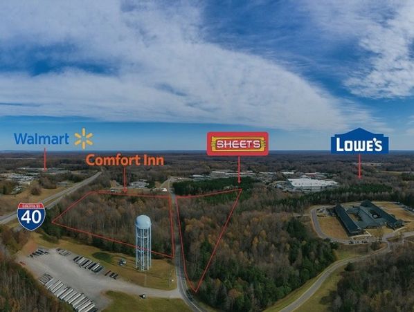 Aerial view of land near I-40 with stores and hotels marked.