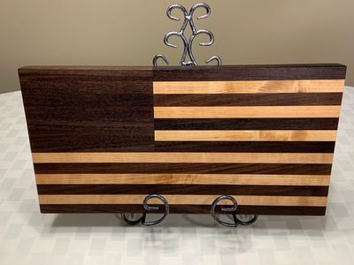 This walnut and maple flag is made with local boards from the USA .