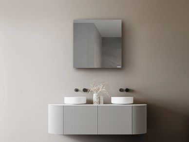 Minimalist bathroom vanity with two sinks and a square mirror.