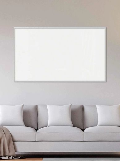 Minimalist living room with a white sofa and blank wall art.