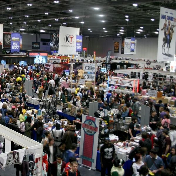 Crowded convention hall filled with attendees and vendor booths.
