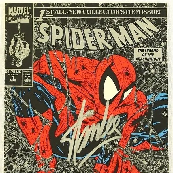 Spider-Man comic cover signed by Stan Lee, featuring webbed background.