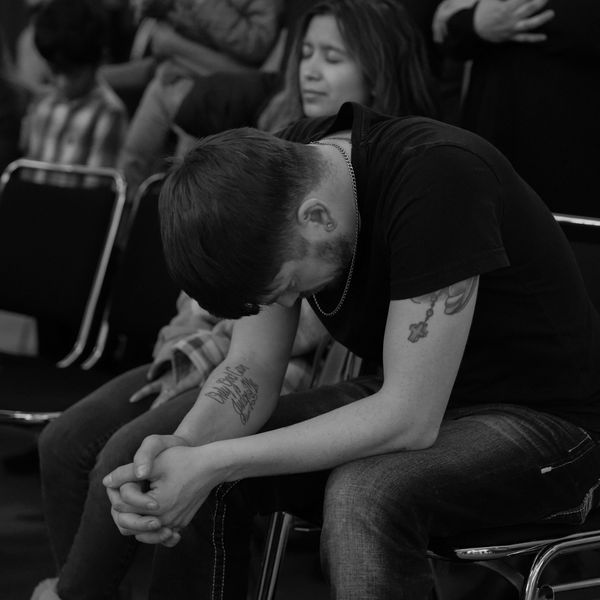 Young man praying at Momentum Church