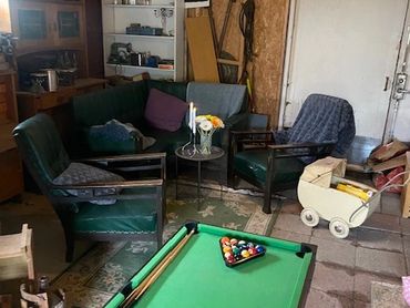 Cozy indoor game room with pool table and vintage seating.