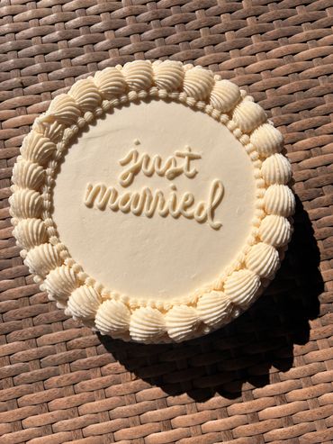 Wedding cake with "just married" written on it.
