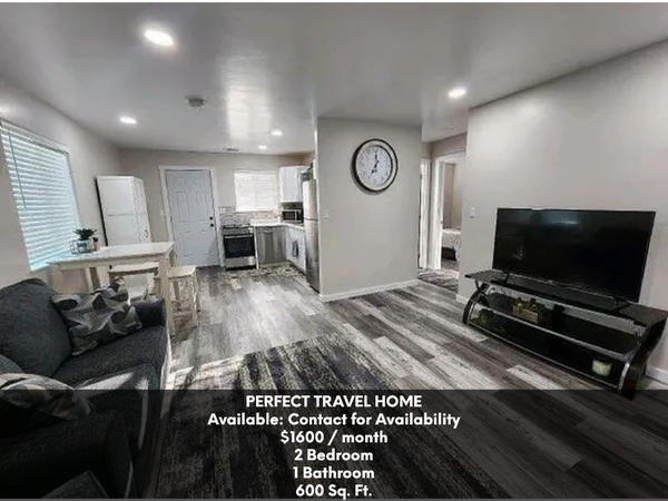 Modern 2-bedroom travel home with open living area, kitchen, and TV setup.