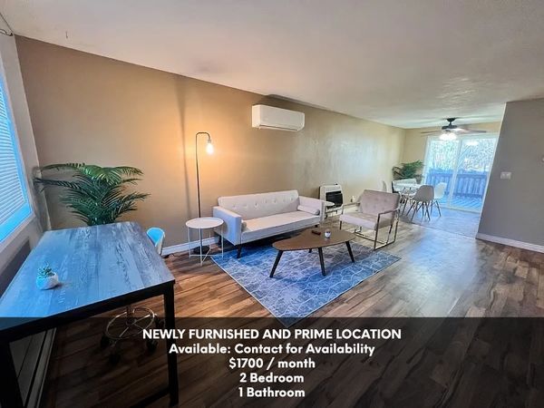 Modern furnished living room with dining area and desk, available September 2025 for $1700/month.