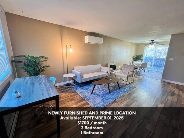 Modern furnished living room with dining area and desk, available September 2025 for $1700/month.