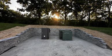 Large new construction retaining wall built into hill to stop overflow and promote useable space
