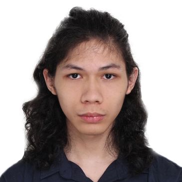 Portrait of a young person with long curly hair and a neutral expression.