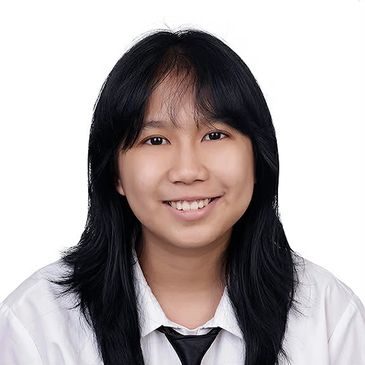 Smiling young woman with long black hair in white shirt and black tie.