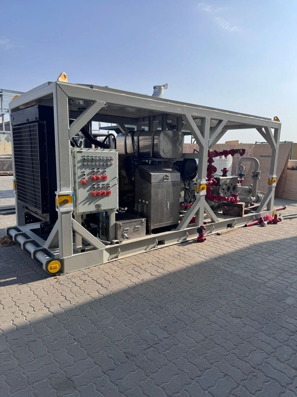 Industrial machinery unit with control panel and piping in an outdoor setting.