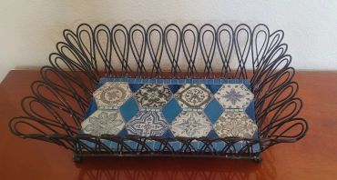 Decorative wrought iron basket with patterned tile base