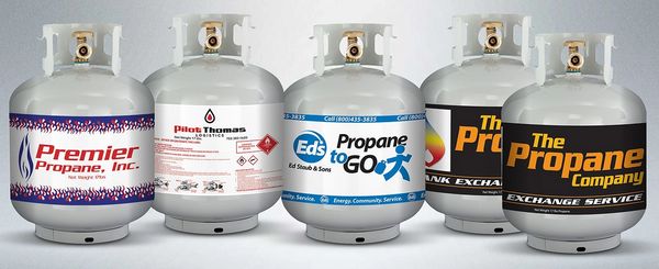Several Propane exchange tanks with colorful labels.