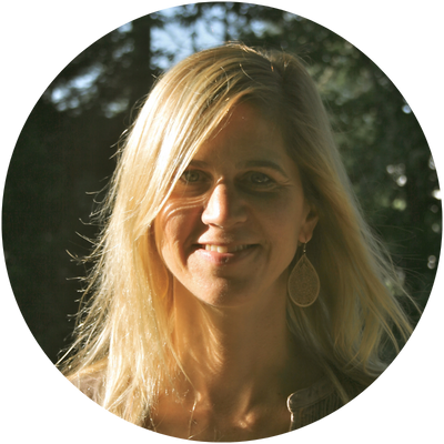 Confident man in a suit smiling while walking outdoors, showcasing fashion and style.