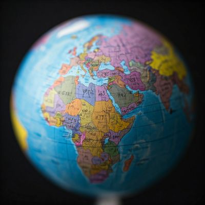 The image depicts a highly stylized globe with the words "International Tax" written on it.